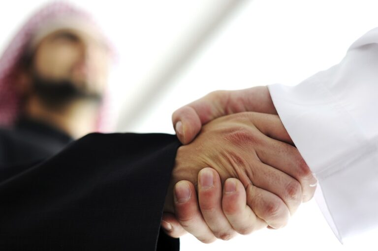 Closeup of business people shaking hands over a deal